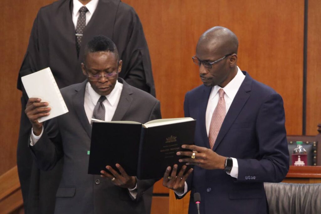 Temporary government senator Augustus Thomas, left, takes the oath of office in the Senate in 2019.  - Photo courtesy Parliament