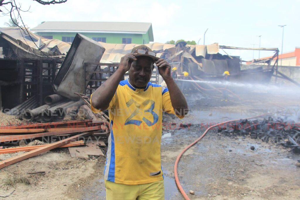 COUNTING HIS LOSSES: An emotional Carl Sampson was left counting his losses after his block and pallet factory and warehouse in Sangre Grande was destroyed by fire on Sunday. Photo by Ayanna Kinsale