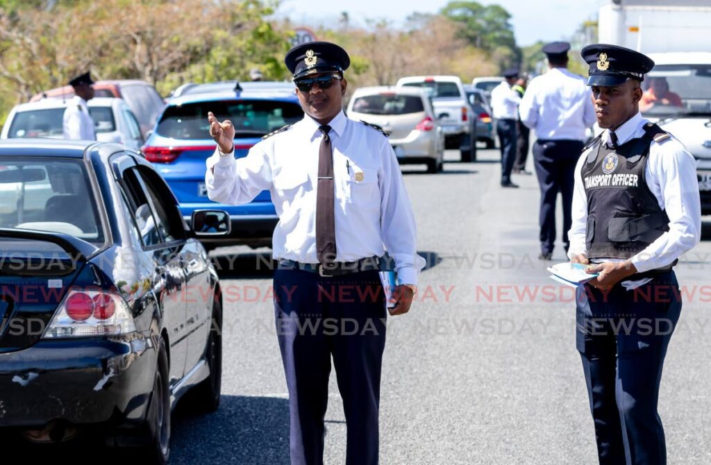 Licensing Officers and Traffic Police conduct a traffic exercise at Shirvan Road, Tobago last Friday. - David Reid