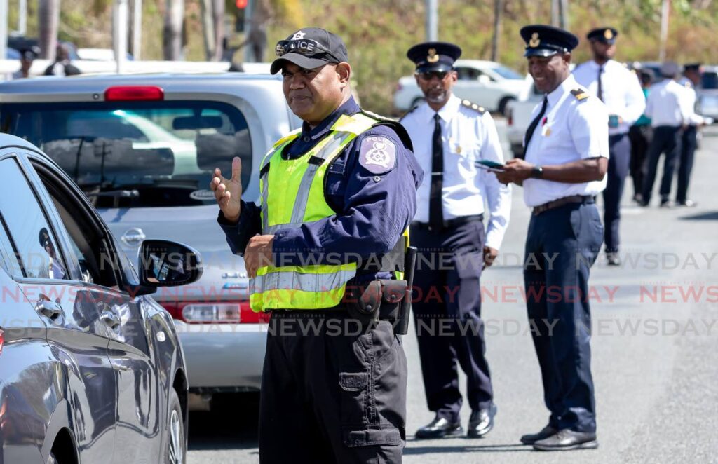 Traffic police and licensing offiers conduct a traffic exercise at Shirvan Road, Tobago, last Friday. Photo by David Reid