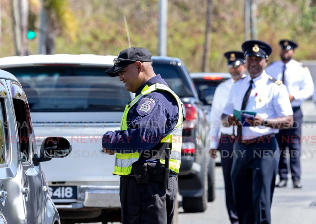 Police and licensing officers stop drivers to check their documents during an exercise in Tobago on April 14.  - David Reid