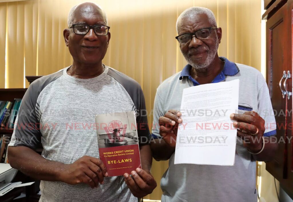 Former Works Credit Union president Fitzroy Ottley, left, and education committee member Neville Warner. - ROGER JACOB