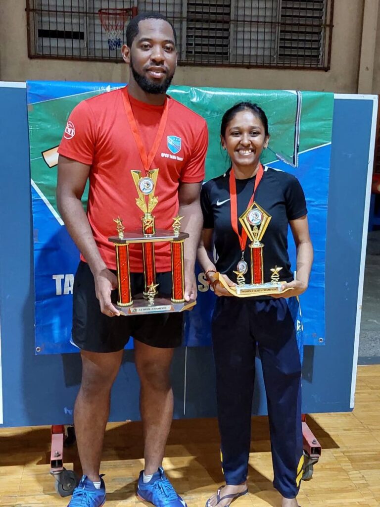 Men's A1 division champ Shemar Britton and Women's A1 division champ Ambika Sitram (R) display their trophies after winning the Classified Table Tennis Tournament, on Sunday, at the Eastern Regional Indoor sport Arena, Tacarigua. - 