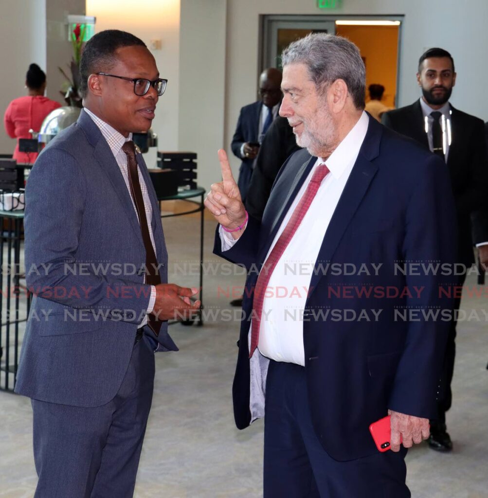 Prime Minister of St Vincent and the Grenadines Dr Ralph Gonsalves, right, with Minister of Foreign and Caricom Afffairs Dr Amery Browne, at the regional anti-crime symposium at the Hyatt Regency, Port of Spain on April 18. - ROGER JACOB