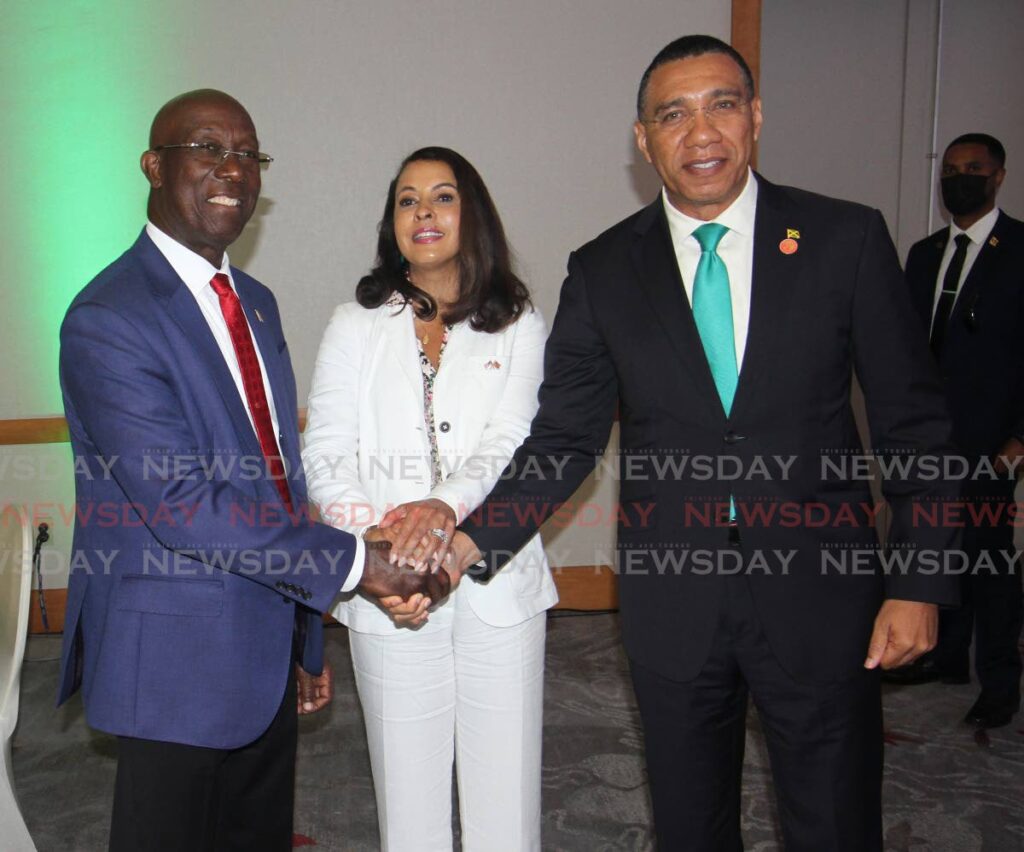 HANDS OF FRIENDSHIP: Prime Minister Dr Keith Rowley, left, US Ambassador to TT Candace Bond, and Jamaica's Prime Minister Andrew Holness shake on Tuesday at the end of the two-day Caricom symposium on crime at the Hyatt Regency in Port of Spain. PHOTO BY ANGELO MARCELLE  - Angelo Marcelle