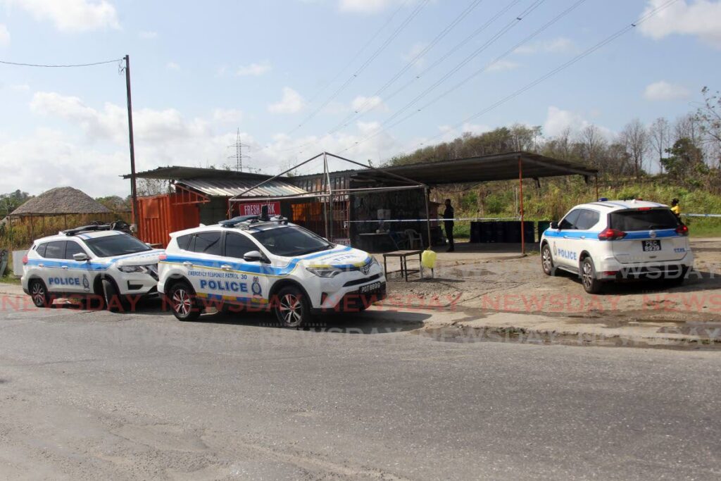 Police at the scene of the murder of Daniel Eversley at Springvale Junction, Claxton Bay on Tuesday morning. - Lincoln Holder