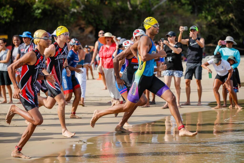 Jean-Marc Granderson is first into the water at the TT Triathlon Federation’s (TTTF) National Aquathlon held at Las Cuevas Beach on Sunday.
 - Courtesy Richard Lyder