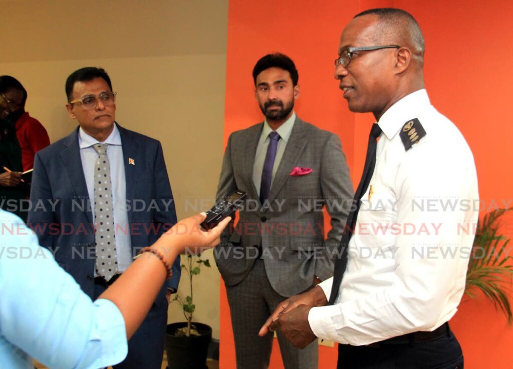 Transport Commissioner Clive Clarke, right, speaks to the media during a press conference at the Ministry of Works and Transport on Richmond Street, Port of Spain. Looking on are Minister of Works and Transport Rohan Sinanan, left, and Minister in the Ministry of Works and Transport Richie Sookhai.  - AYANNA KINSALE