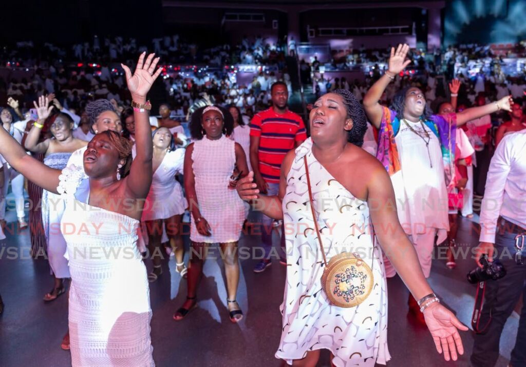 The audience on their feet singing, clapping and dancing at the Tobago Jazz Experience's gospel night showy. - David Reid