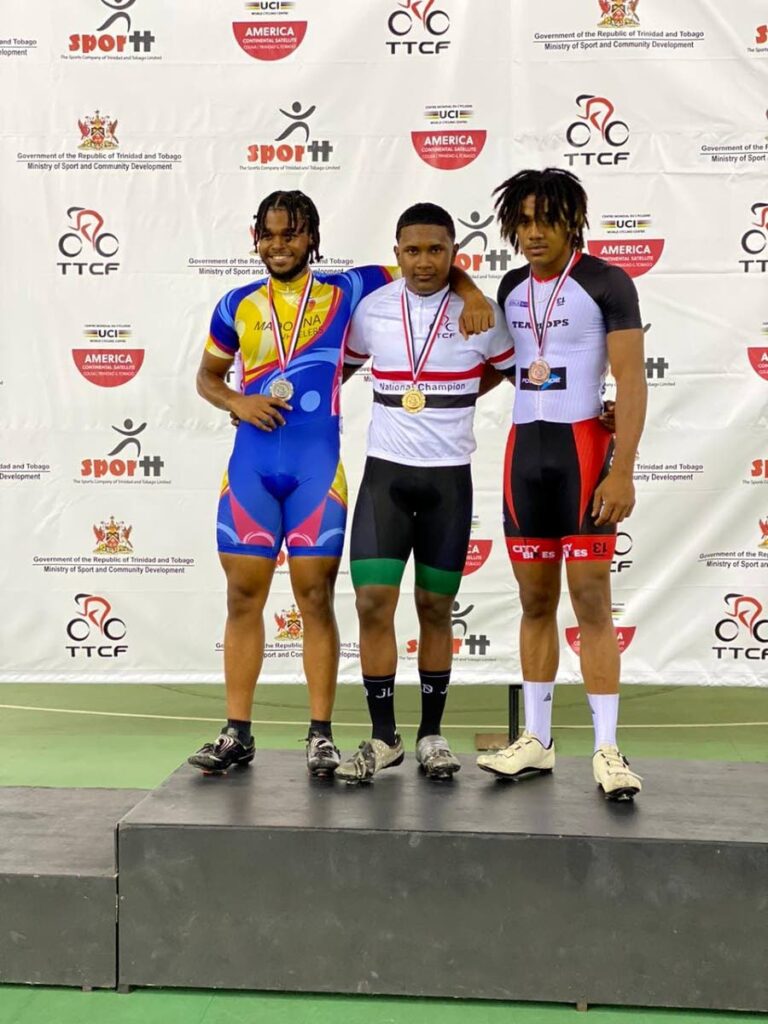 Newly crowned national junior men keirin champion Syndel Samaroo (JLD Cycling Academy), centre, celebrates his golden performance alongside silver medallist Raul Garcia (Madonna), left, and bronze receiver Jarel Mohammed (DPS) on Friday.  - 