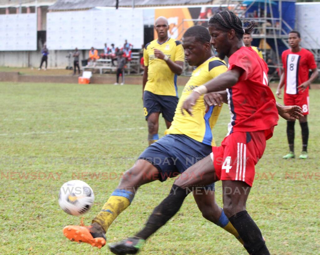 Malik Mieres of Caledonia FC, right, and Kendell Hitlal of Defence Force FC, challenge for the ball during their TT Premier Football League match at the Police Training Ground, St James on Sunday.  - ANGELO MARCELLE