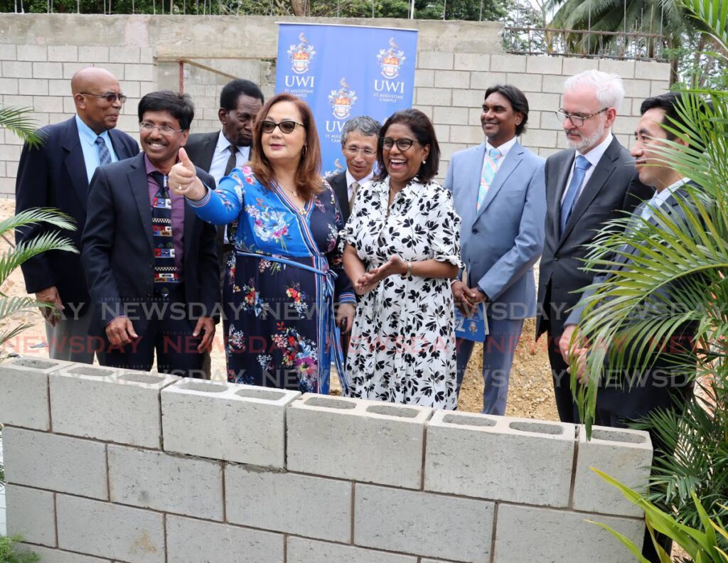 BIG THUMBS UP:
UWI St Augustine Principal Professor Rose-Marie Belle-Antoine gives the media cameras a thumb up after she placed a concrete block at the site of the UWI Commercial Chocolate Factory alongside Trade Minister Paula Gopee-Scoon, Professor Pathmanathan Umaharan Director of CRC,  Winston Rudder, Dr John Alleyne Special Advisor at OPM, Japan Ambassador Matsubara Yutaka, Deputy PS Agriculture Minister Ric Javed-Ali, Head of Delegation European Union Peter Cavendish and Mr Zhou Lichun Economic and Commerical Affairs Counselor Chinese Embassy to TT. - Photo by Roger Jacob