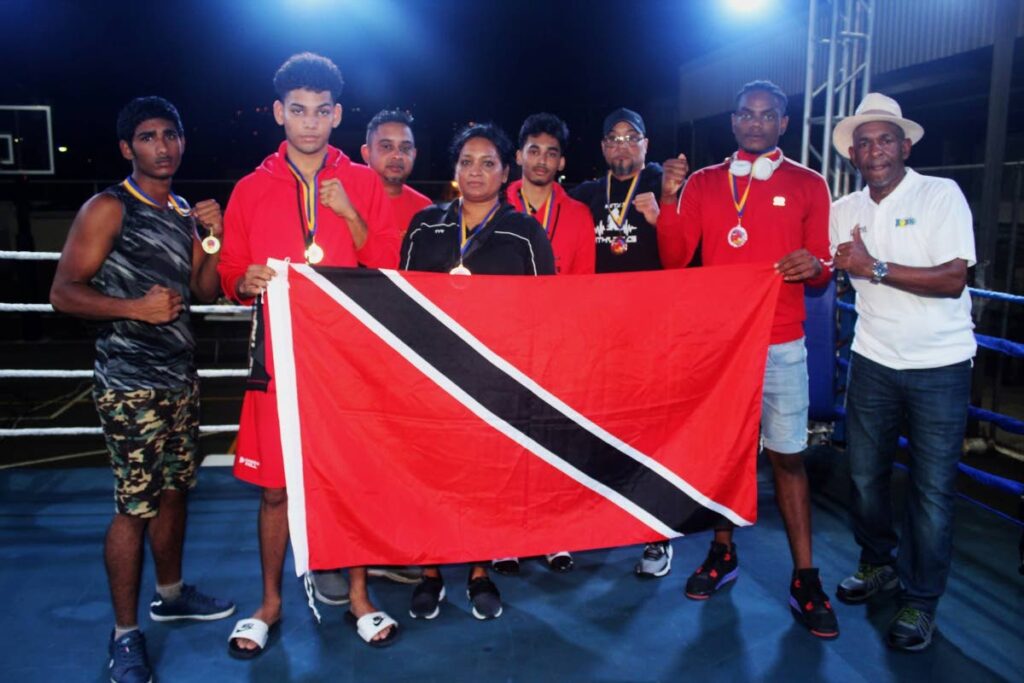 TT's junior boxers and team staff show off their three gold and one bronze medal captured at the Caribbean Champions of Champions Boxing Tournament in St Lucia over the weekend.  - TTBA