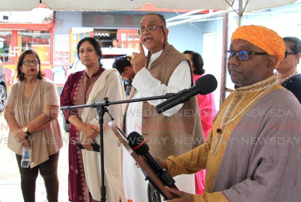 Pundit Dr Bramanand Rambachan, centre, and Pundit Satyanand Maharaj, right, address a press conference on crime at Madeo's Mini Plaza, Aranguez on Wednesday.  - AYANNA KINSALE