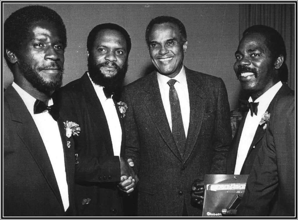 Harry Belafonte, second from right, meets Desperadoes' musicians, Fitzroy Alexander, left, Edison Holder and Denzil Botus. - Courtesy Mervyn Bamby