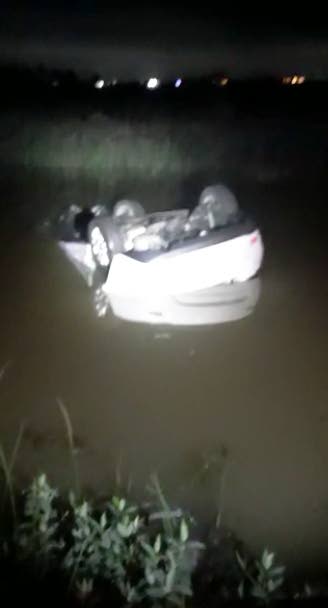 OVERTURNED: A screen-grab of a video posted to social media showing a car on its hood and partially submerged in a swamp near the Caroni Bird Sanctuary during the early morning hours of Thursday.  - 