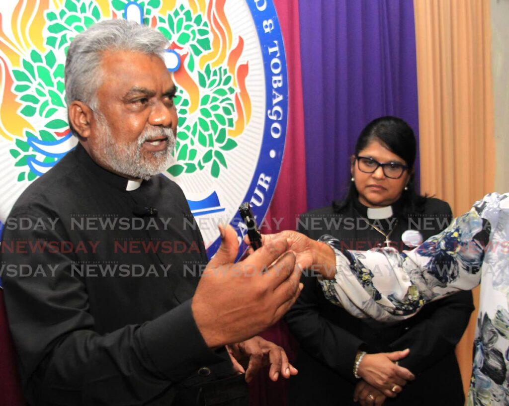 Newly-appointed moderator of the Presbyterian Church during an interview with the media on April 27 at Naparima College, San Fernando. At right, is his predecessor Rev Joy Abdul-Mohan. - Photo by Ayanna Kinsale
