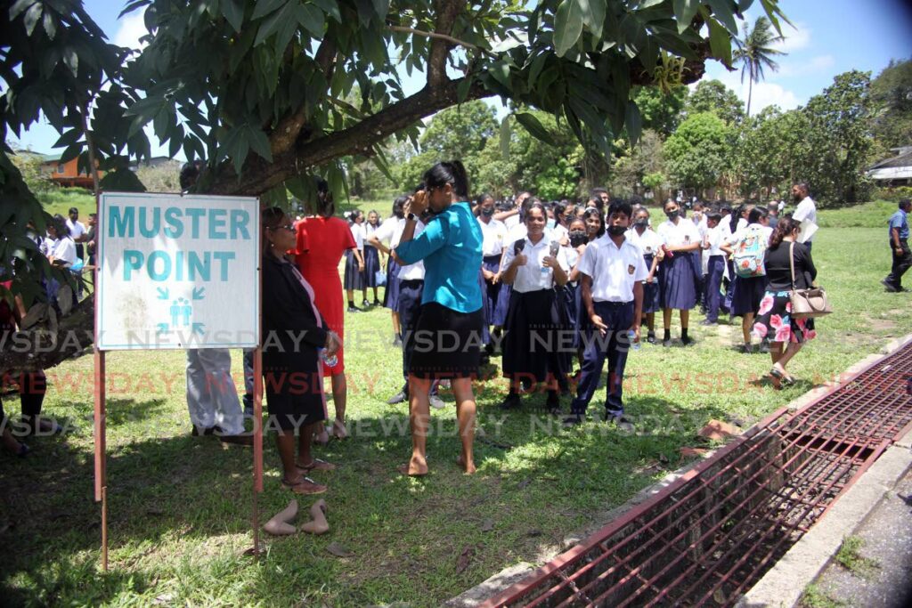Students of Iere High School, Siparia gathered at their muster point after classes were disrupted by an e-mail threat sent to the school on April 29. - Lincoln Holder
