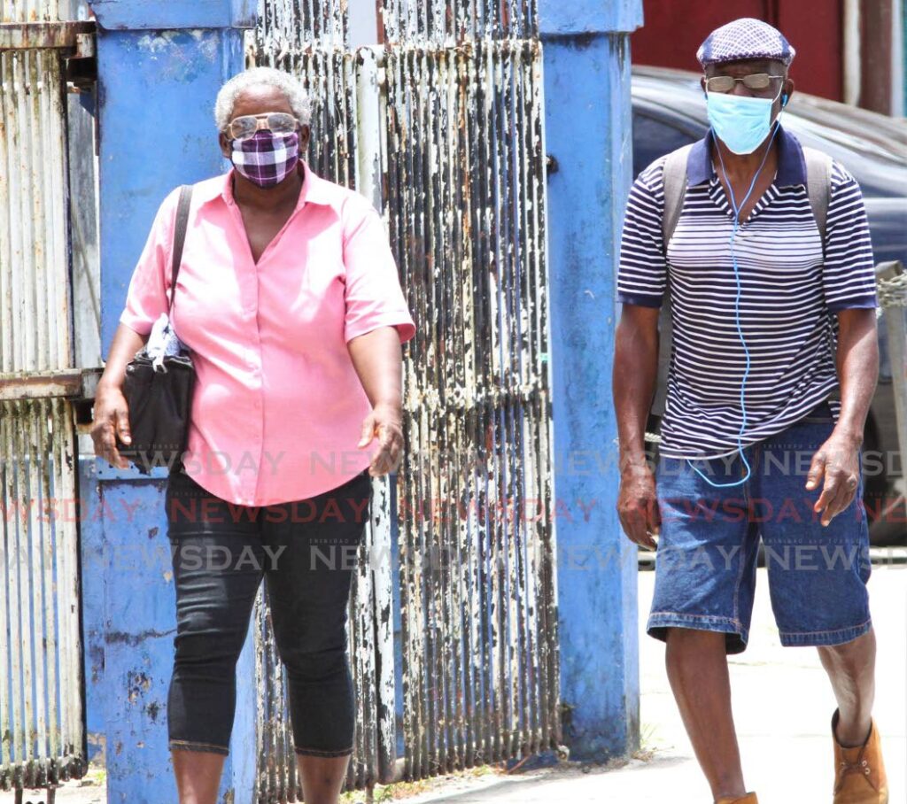 Senior citizens walk along the Eastern Main Road in Sangre Grande in 2020. File photo - 