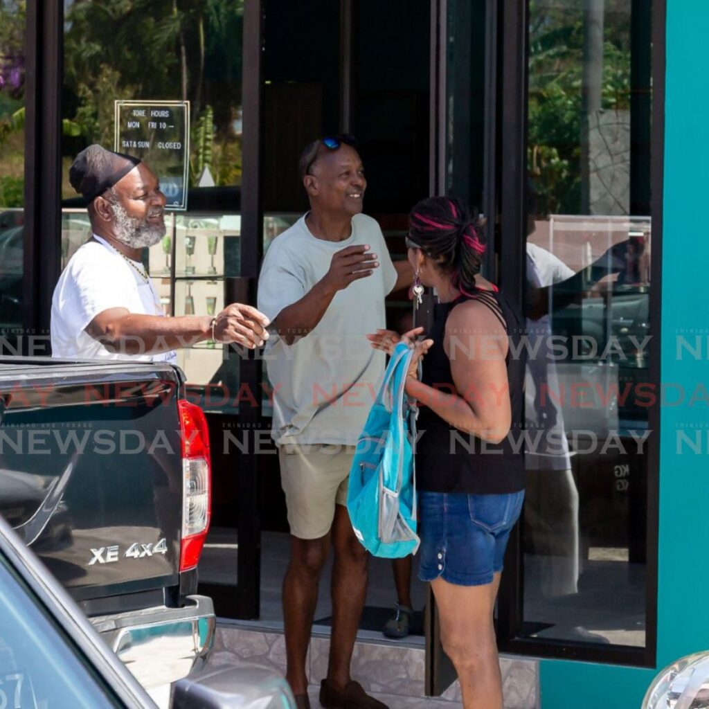 Ian/Darlington: Mr Ian Darlington, left, owner of Cowie's Bakery, welcomes some early morning customers before opening time at Carnbee Mian Road, Tobago last Monday. Photo by David Reid 