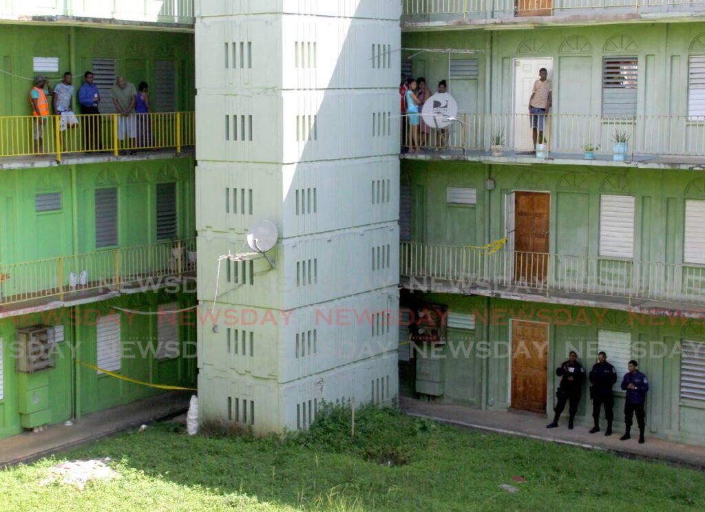 Police keep watch on the ground level of a building at Maloney Gardens. - File photo/Roger Jacob