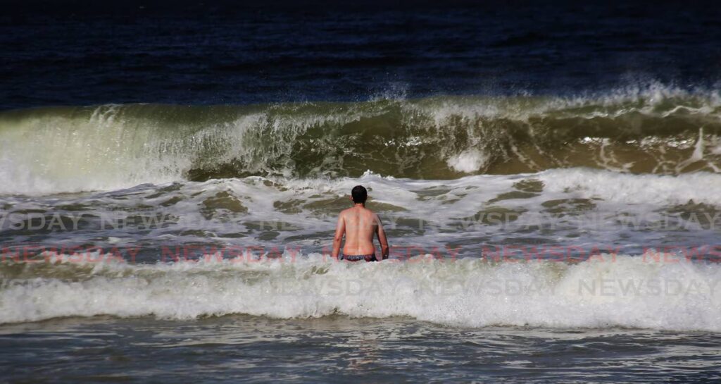 A man braces for waves at Maracas Beach.  - File photo/Sureash Cholai