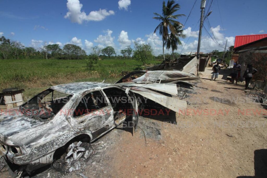 Two houses and a car burnt in Trainline, St Augustine. That troubled community has seen at least six murders so far this year. Trainline on Sunday night. FILE PHOTO - 