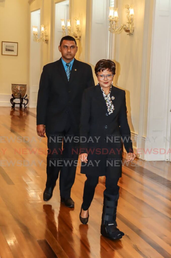 President Christine Kangaloo still nursing a leg injury is escorted to preside over the swearing-in ceremony of Minister in the Ministry of Works and Transport Richie Sookhai at President's House, St Ann's on March 14. - Roger Jacob