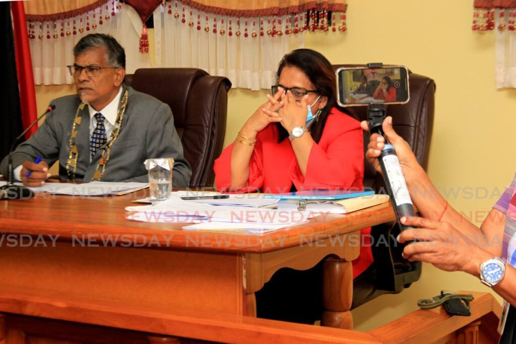 Siparia Regional Corporation CEO Ann Hosein reacts to questions posed to her during the coporation's statutory meeting at the Siparia Regional Corporation, Siparia, on Thursday as corporation chairman looks on. - Photo by Ayanna Kinsale