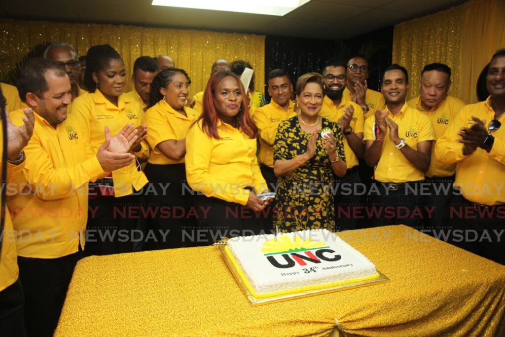 UNC political Leader Kamla Persad-Bissessar, yellow and black dress, surrounded by MP's and other party members at the opening of the party's new headquarters at Mulchan Sieuchan Road, Chaguanas, on May 1. - Lincoln Holder