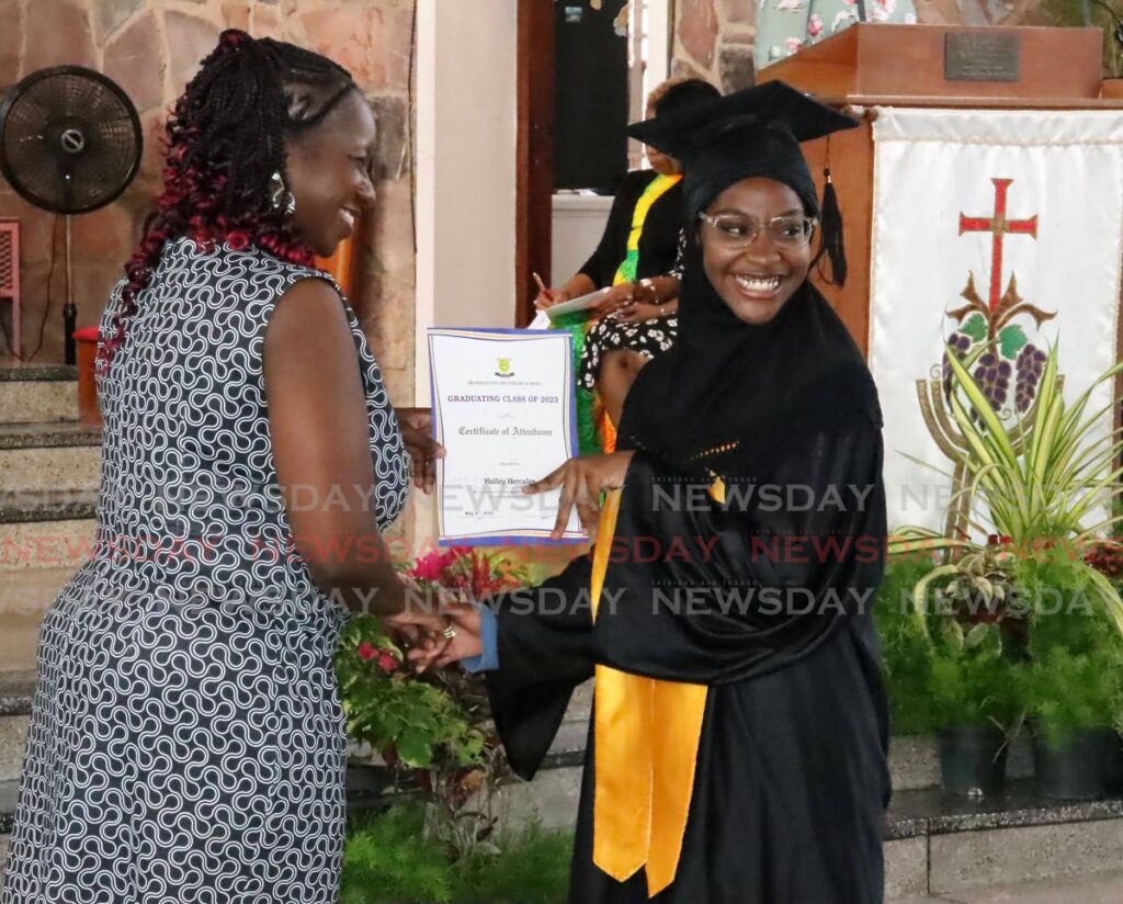 PROUD MOMENT: Hailey Hercules receives her school-leaving certificate during the Tranquility Secondary School graduation ceremony at the Church of the Assumption, Long Circular Road, Maraval on Thursday. PHOTO BY ROGER JACOB - ROGER JACOB