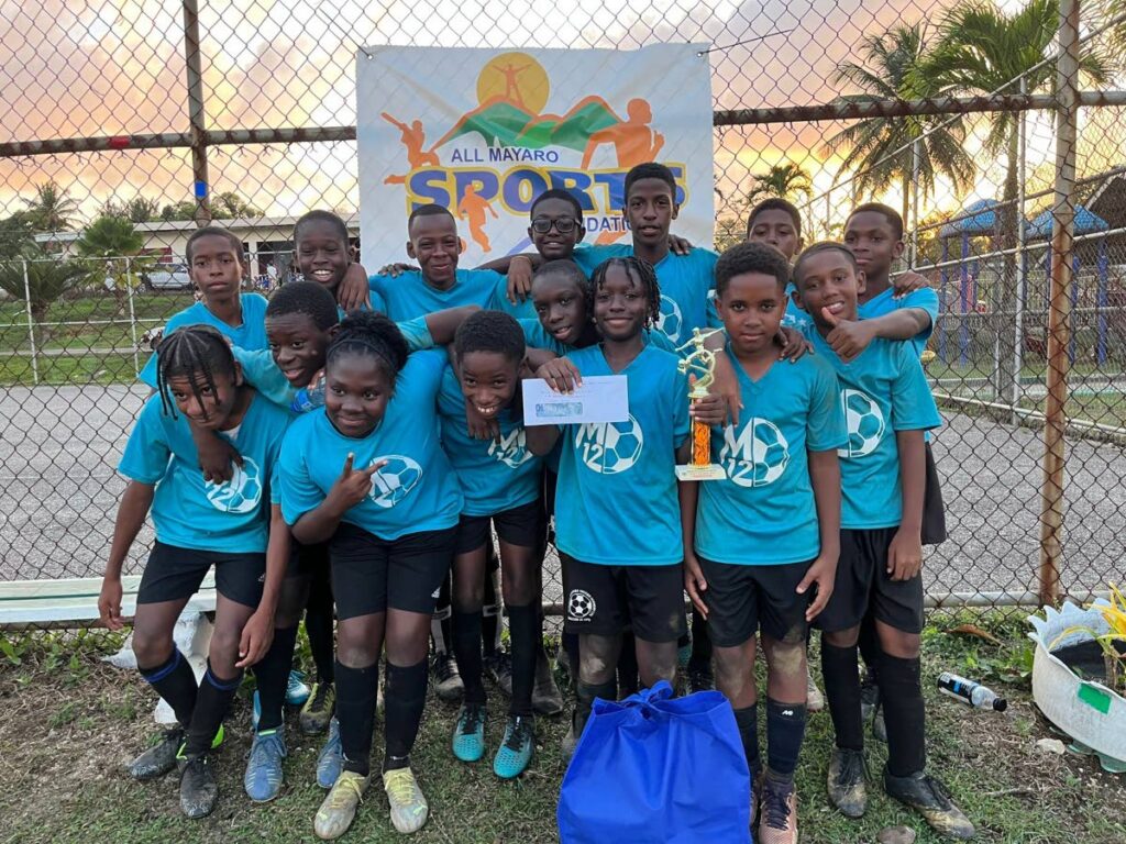 M12 Revolution players celebrate victory at last weekend's Seed of Greatness Biche Football Development School under-11 tournament.  - 