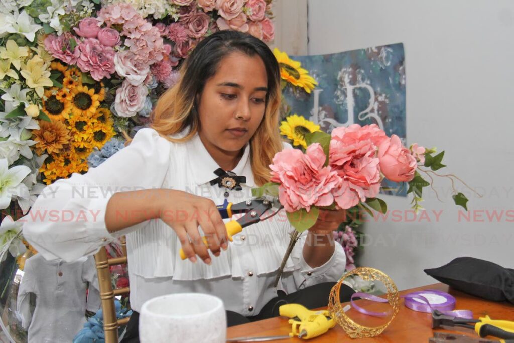 House of Blooms TT owner and founder Aliza Missire cuts flowers for a floral balloon arrangement. - Marvin Hamilton