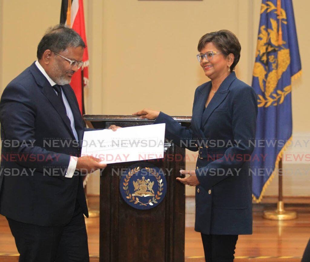 PROUD OF YOU BRO: President Christine Kangaloo presents the appointment of the status of Senior Counsel to her brother Colin Kangaloo on Monday at President's House in St Ann's. PHOTO BY AYANNA KINSALE - 