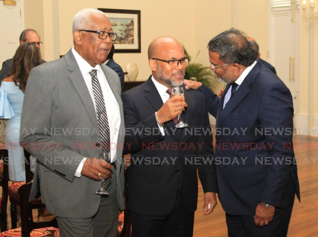 President Christine Kangaloo’s husband Kerwyn Garcia, SC, speaks with his brother-in-law Colin Kangaloo, SC, (right), while Garcia’s father and former education minister and PNM MP Anthony Garcia listens during the award of silk ceremony on Monday at President’s House, St Ann’s. PHOTO BY AYANNA KINSALE  - 