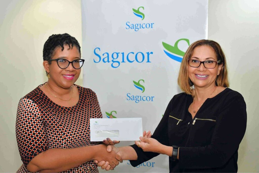  Sagicor finance manager Gina Paul-Schwartz, left, presents a cheque to  Caribbean Kids and Families Therapy Organisation’s vice chairperson Sofia Figueroa-Leon, at Sagicor’s head office in Port of Spain. - 