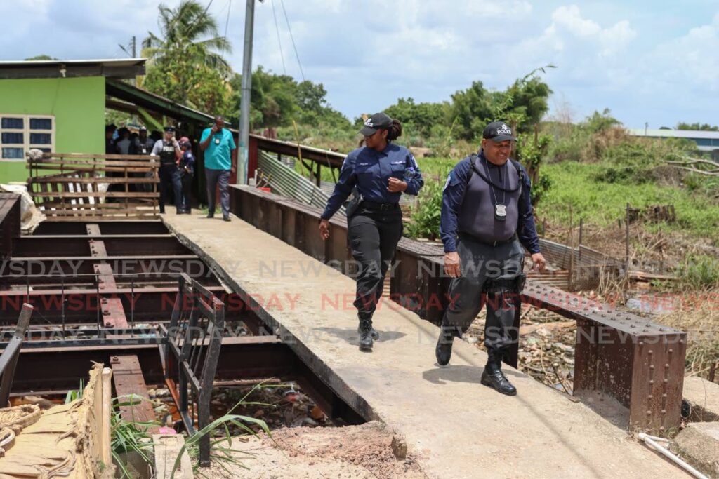 Police during their walkabout in the troubled Trainline, St Augustine community. PHOTO BY JEFF MAYERS 