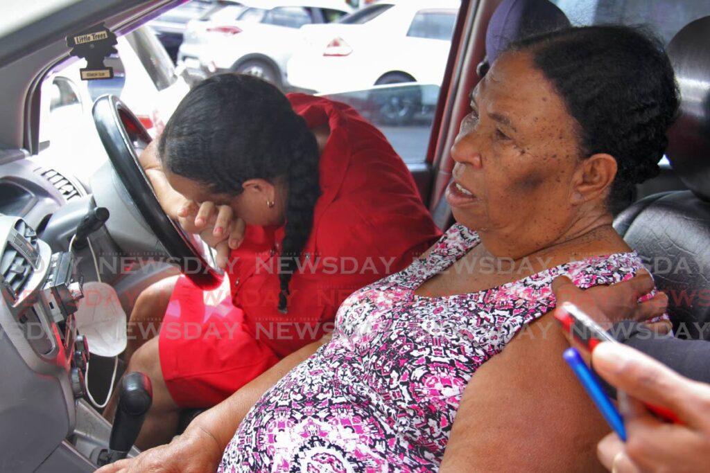 TEARS: Winnie Subero weeps in her car next to her grandmother Agnes as they spoke about the death of Winnie's nephew Marvin Subero, who died on Friday, two days after his car crashed in Gasparillo. PHOTO BY MARVIN HAMILTON - 
