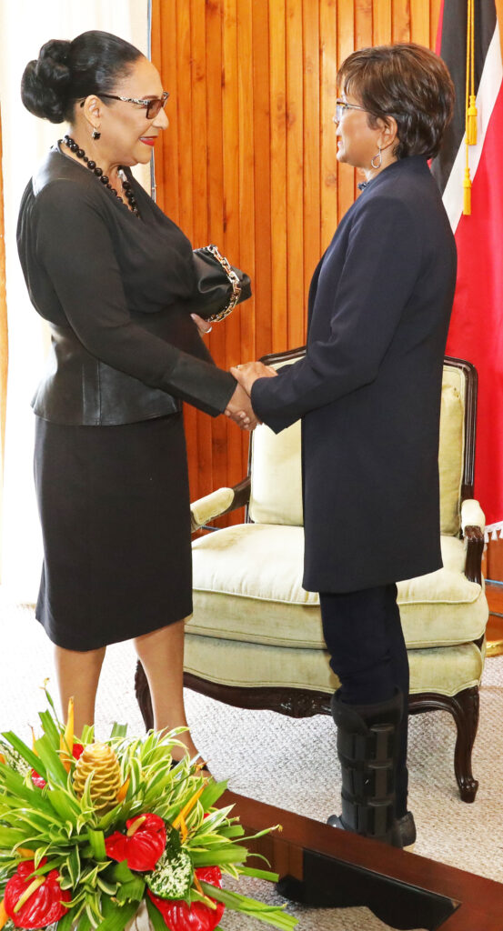 WARM GREETINGS: President Christine Kangaloo, right, warmly greets Law Association president Lynette Seebaran-Suite on Friday at President's House, St Ann's where she have Seebaran-Suite her letter of appointment as Senior Counsel (SC). PHOTO COURTESY OFFICE OF THE PRESIDENT - 