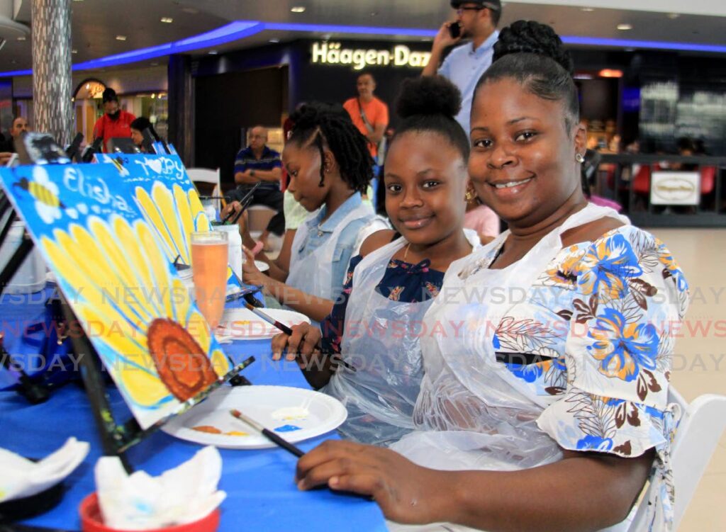 Elisha Sylvester, left, shares a moment with her mother Crystal Toby during the Arty Party Mummy and Me Sip and Paint at Gulf City Mall, La Romaine. 