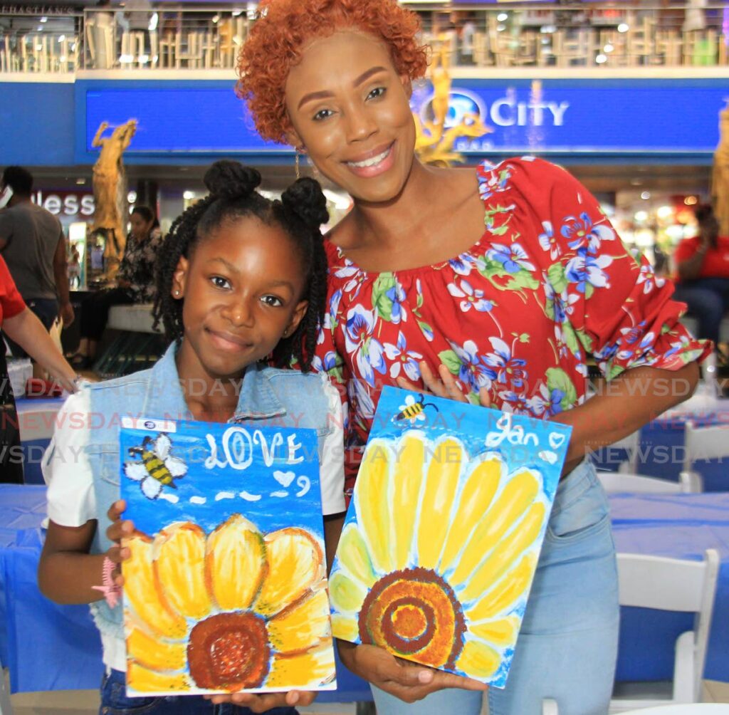 Janellleia Roberts and her daughter Jannique Jerry show off their paitings at the Arty Party Mummy and Me Sip and Paint at Gulf City Mall, La Romaine.