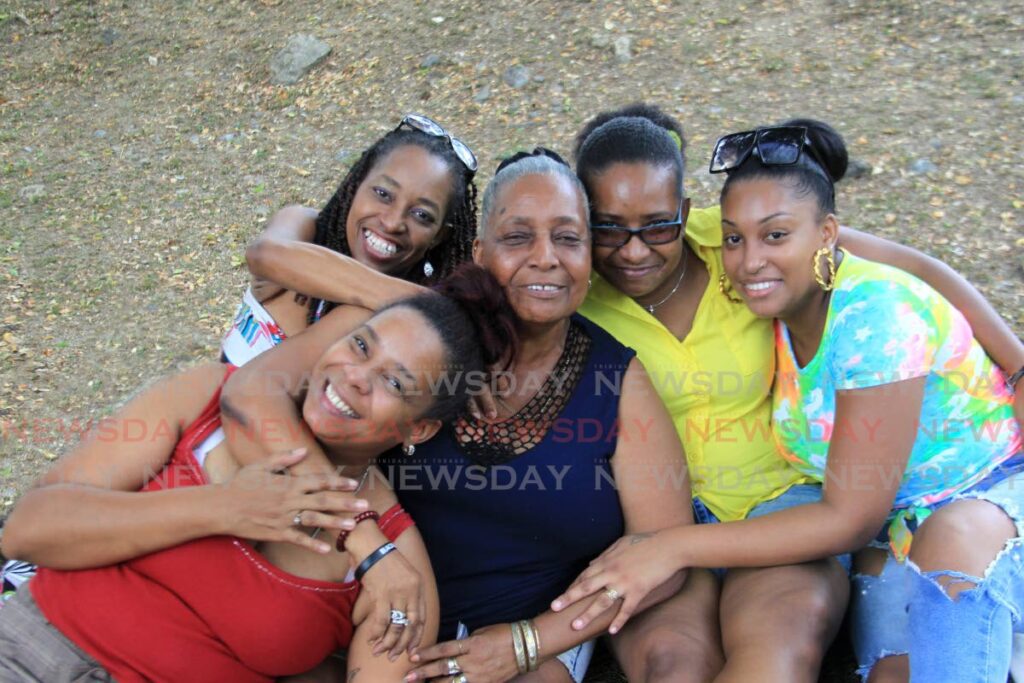 Jacqueline Alleyne, centre, is surrounded by her daughters, from left, Stacy Alleyne, Andrea Pickering, Natasha Nagee, and granddaughter Shanelle Mohammed-Griffith at Palmiste Park, San Fernando.