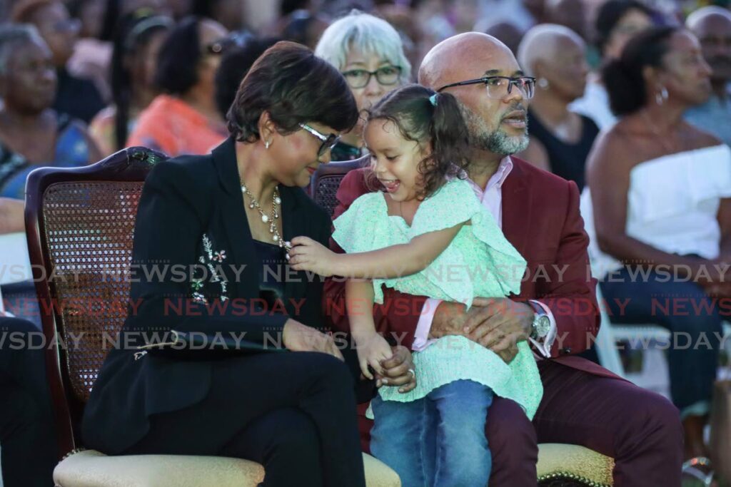 President Christine Kangaloo, her husband, Kerwyn Garcia, and his god daughter Ife Mayers, grand daughter of the late Richard “Nappy” Mayers, enjoy the music at the Mother’s Day concert at the band stand of President’s House on Sunday. The event was hosted by the President and produced by BP Renegades. - Jeff K. Mayers 
