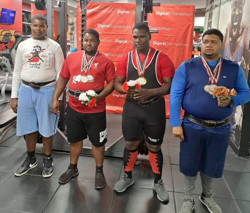 Special Olympics athletes, from left, Shaquille Davis, Carlos King, Malachi Sylvester and Adam Lawrence, at D’ Dial Fitness Club, Long Circular Mall, St James after competing in National Games weightlifting on Saturday.  - SOTT