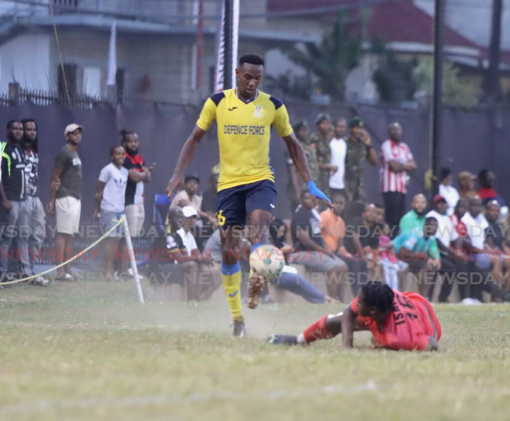 Defence Force defender Justin Garcia, left, leaves Terminix La Horquetta Rangers' Isaiah Lee on the ground in a TT Premier League match at the Police Barracks Grounds, St James, Tuesday.  - ROGER JACOB