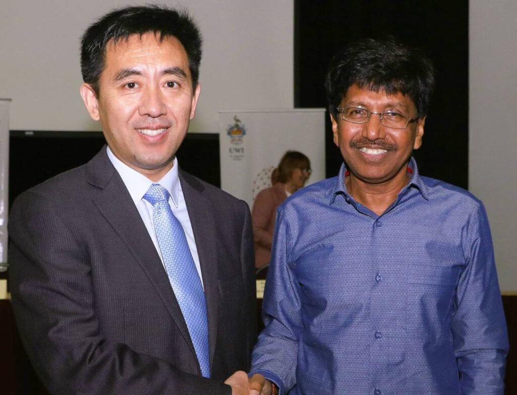 GREETINGS: Counsellor at the Chinese Embassy Lichun Zhou shakes hands with director of the UWI, St Augustine campus’ Cocoa Research Centre, Prof Pathmanathan Umaharan. PHOTO COURTESY THE UWI