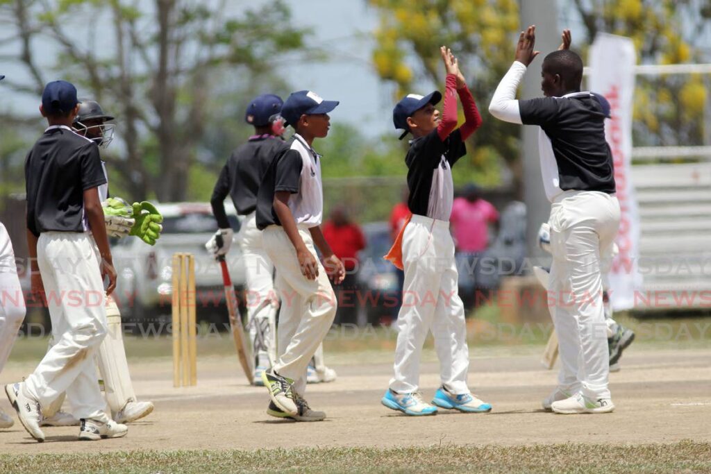 South West Zone teammates celebrate a wicket against Central Zone during the final of the Scotiabank NextGen Under-13 cricket tournament, at the National Cricket Centre, Couva, on Wednesday.  - Lincoln Holder