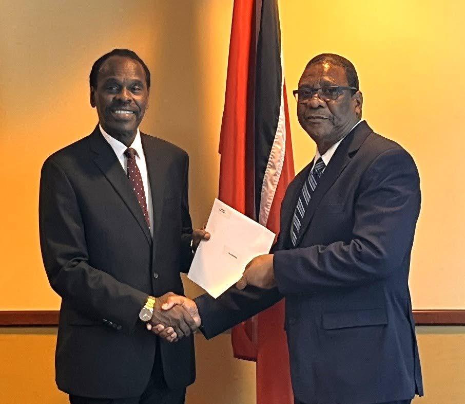 Minister of National Security Fitzgerald Hinds presents
letters of appointment to chairman of the Criminal Injuries Compensation Board Alvin Pascall on Monday. 
PHOTO COURTESY MINISTRY OF NATIONAL SECURITY 

