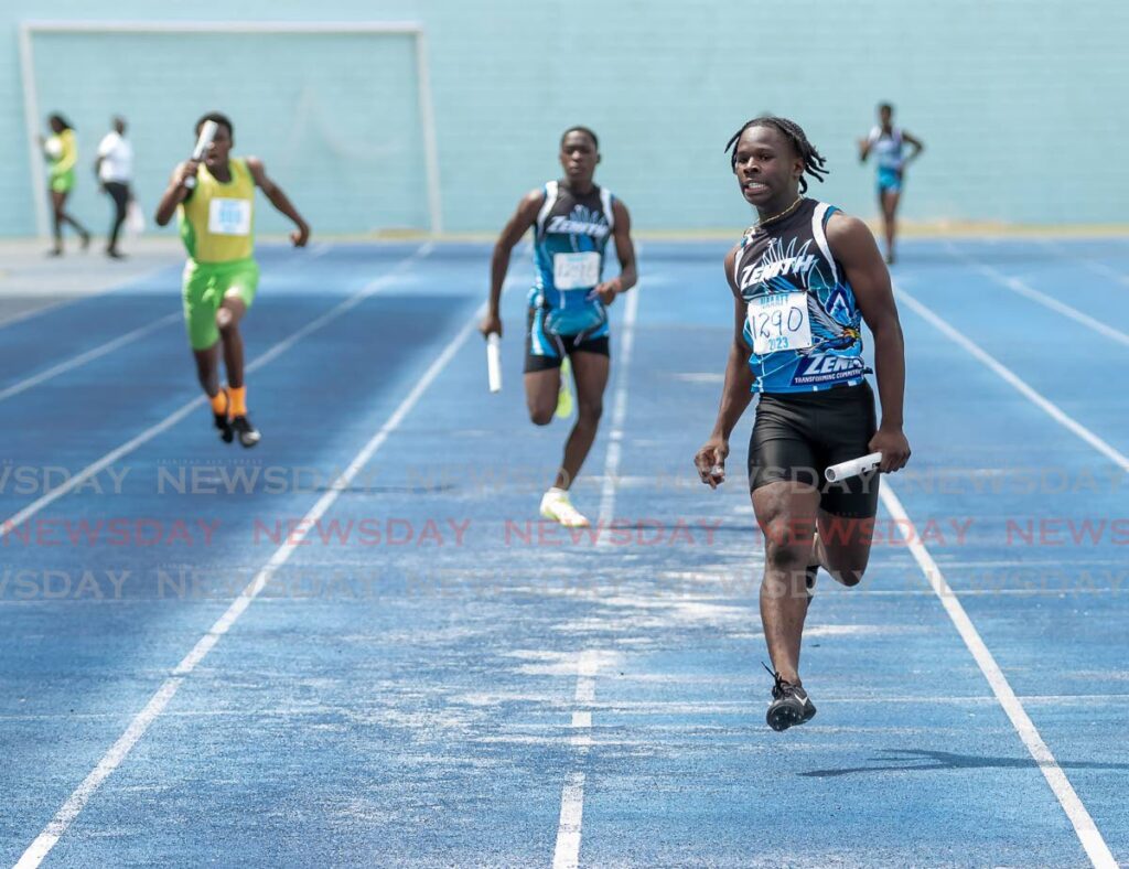 Malakai Cordner, right, of Zenith Club powers to victory in the under-17 4x100 mixed relay, at the Zenith's Relay and Field Festival 2023 at Dwight Yorke Stadium, Bacolet, Tobago, Sunday. - David Reid