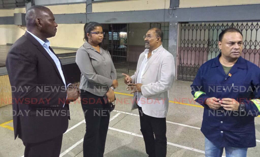ODPM CEO Major General (Retired) Rodney Smart, left, chats with Cumuto/Manzanilla MP Dr Rai Ragbir, right, and Katherine Badloo Doerga, director, drainage division, Ministry of Works, as Anil Juteram,chairman, Sangre Grande Regional Corporation looks on at North Easterm College, Sangre Grande, Thursday. - Photo by Stephon Nicholas